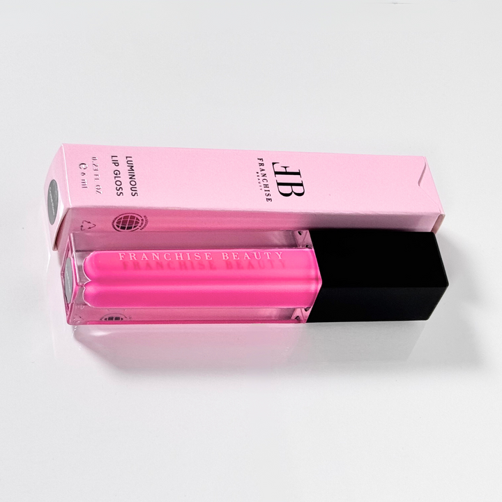 Close-up of pigmented pink Crystal Rose lip gloss with recyclable packaging
