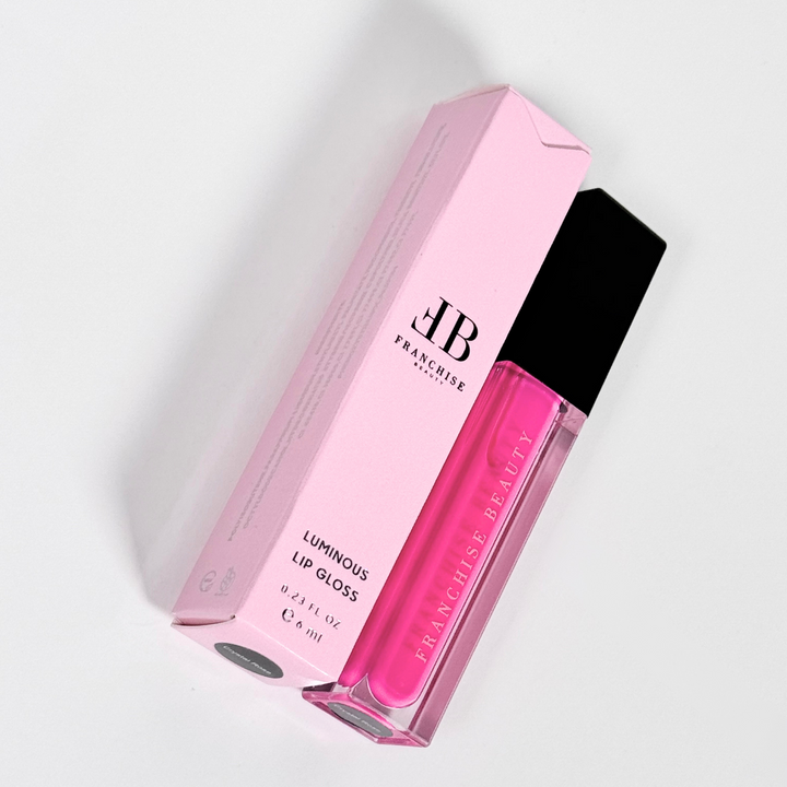 Close-up of pigmented pink Crystal Rose lip gloss with recyclable packaging