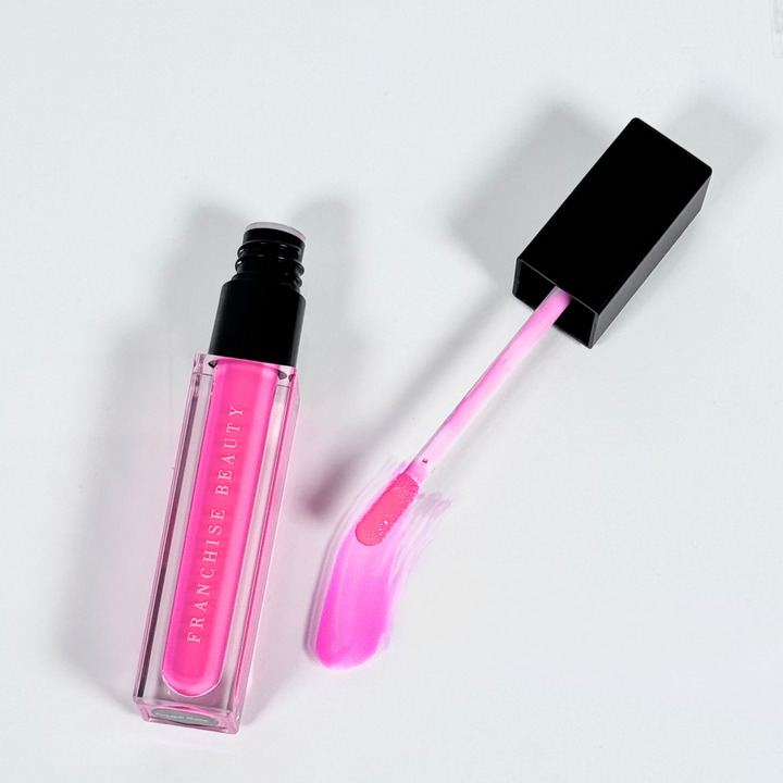 Crystal Rose vibrant fuchsia lip gloss in clear tube with glossy finish