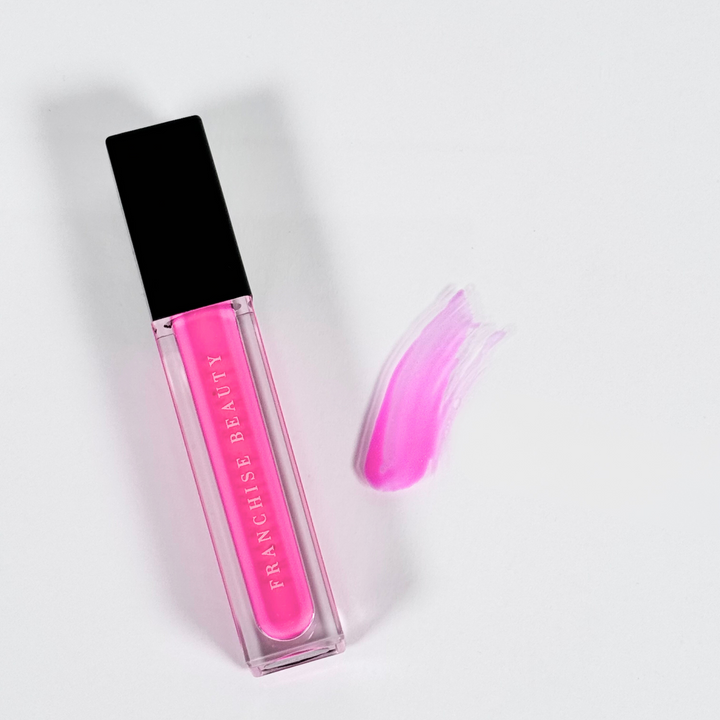 Crystal Rose vibrant fuchsia lip gloss in clear tube with glossy finish