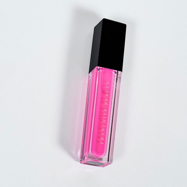 Crystal Rose vibrant fuchsia lip gloss in clear tube with glossy finish