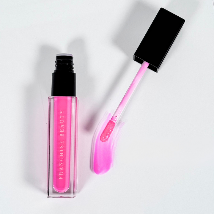 Crystal Rose vibrant fuchsia lip gloss in clear tube with glossy finish