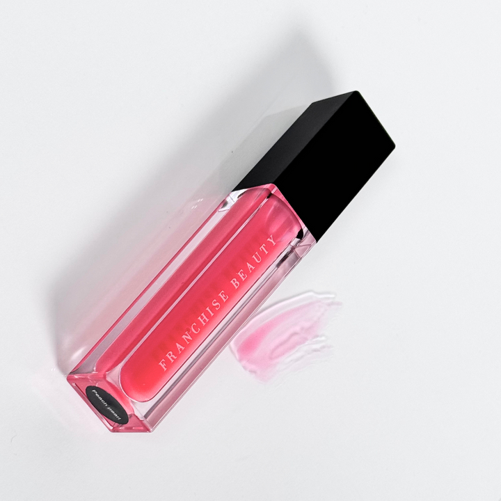 Blush Glass lip gloss in clear tube with sheer pink tint and recyclable packaging