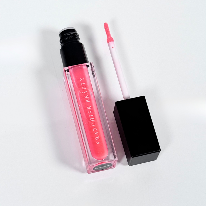 Peach Pearl lip gloss in clear tube with sheer pink tint and recyclable packaging