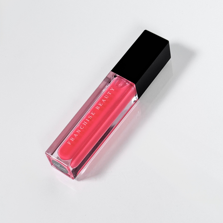Blush Glass lip gloss in clear tube with sheer pink tint and recyclable packaging